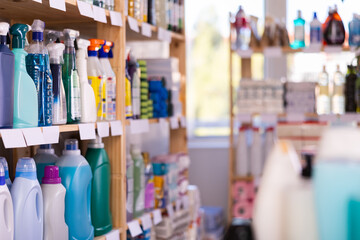 View of big supermarket department with household cleaning products on shelf