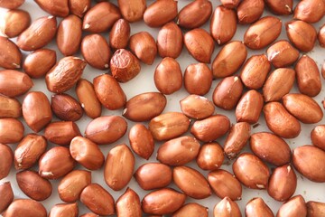 Close up of a pile of pea nuts, with white background, High fat, protein, minerals