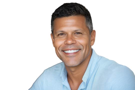 A middle-aged man with short dark hair, smiling confidently at the camera. He is dressed in a light blue shirt, with a slight tilt of his head