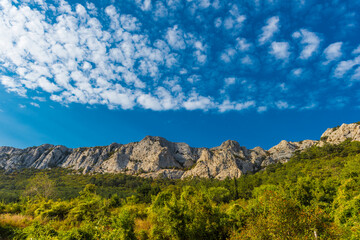 A grand view of the Crimean mountain range under a clear blue sky. 