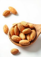 Obraz premium Almonds in a Wooden Spoon on White Background