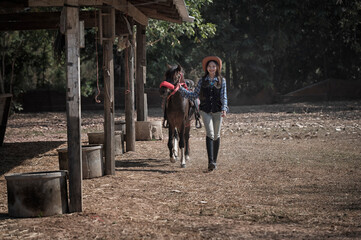 woman riding a horse in farm.	