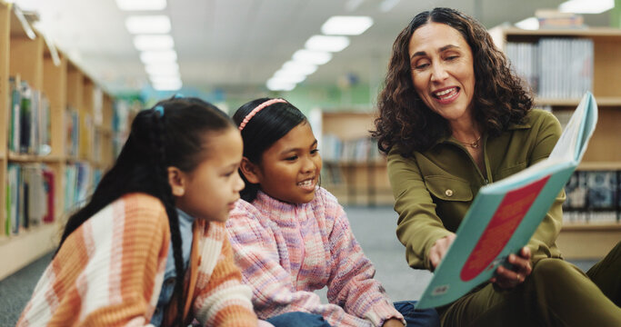 School kids, teacher and education with book at library for development, learning or study with guide. Children, reading and storytelling with woman for help, excited or teaching language at academy - Powered by Adobe