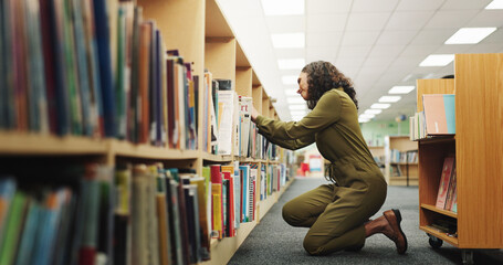 Librarian, woman and books with trolley in library for stock packing, novel arrangement and...