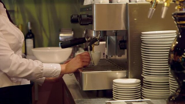 Barista Makes Coffee with a Professional Coffee Machine at a Bar. Barista, Bartender is a Person, Usually a Coffeehouse Employee, who Prepares and Serves Espresso Based Coffee Drinks.