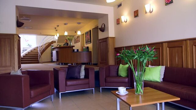 Hotel Waiting Room with Leather Chairs and a Small Coffee Table with Flowers. Lobby is a Room in a Building Used for Entry From the Outside. Sometimes Referred to as a Foyer or Entryway.