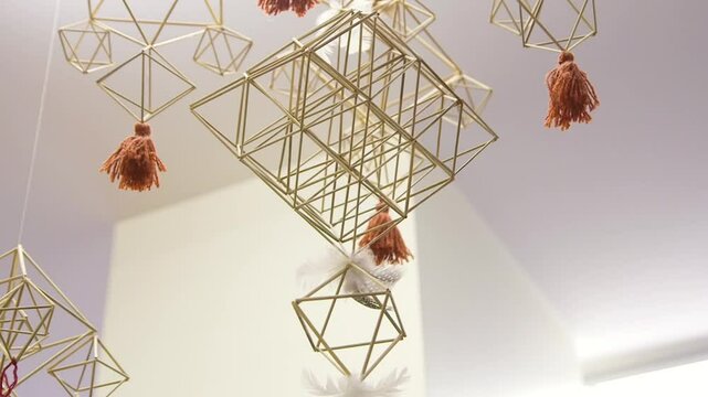 Decorative Straw Mobile with Fringes Hanging from the Ceiling. A Straw Mobile is a Mobile Made From Reeds, Straw or Other Similar Material Bound Together with String, Forming Shapes.