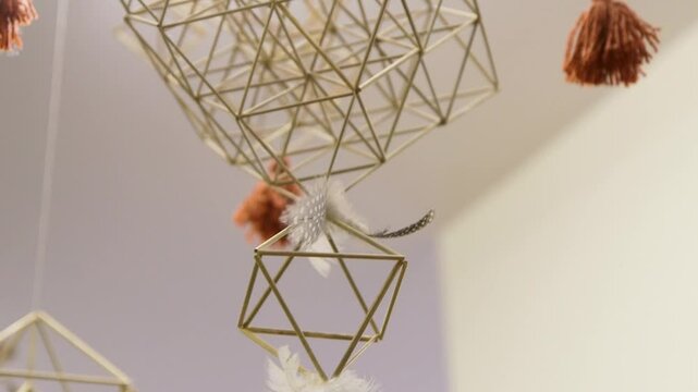 Decorative Straw Mobile with Fringes Hanging from the Ceiling. A Straw Mobile is a Mobile Made From Reeds, Straw or Other Similar Material Bound Together with String, Forming Shapes.