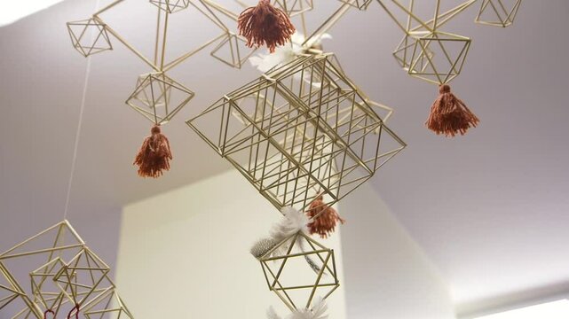 Decorative Straw Mobile with Fringes Hanging from the Ceiling. A Straw Mobile is a Mobile Made From Reeds, Straw or Other Similar Material Bound Together with String, Forming Shapes.