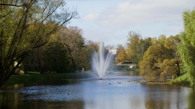Beautiful, Large Fountain in a City Park Pond or Canal. Lots of Ducks. Autumn. Valmiera is One of the Oldest Cities in Latvia, Having Been a Member of the Hanseatic League.