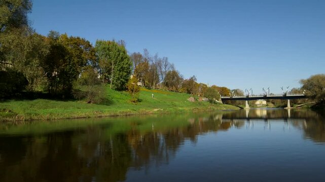 Riverbank in the City and Beautiful Bridge with Arched Shiny Lighting Poles. Valmiera is One of the Oldest Cities in Latvia, Having Been a Member of the Hanseatic League.