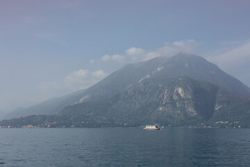Como Lake landscape. Village, trees, water and mountains. Italy, Europe. Nature banner