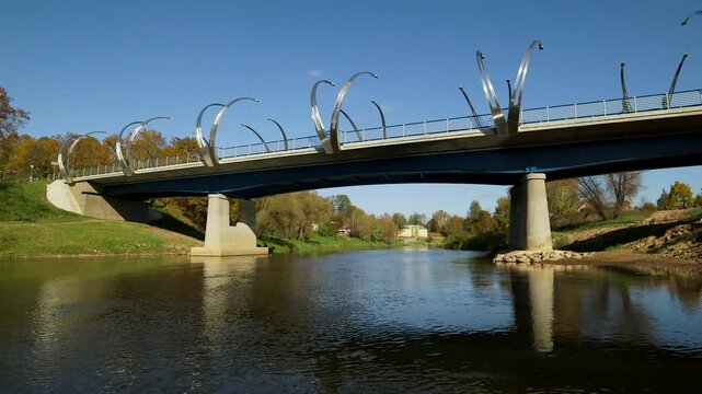 View from a Boat Passing Under a Beautiful Bridge with Arches on the River. Valmiera is One of the Oldest Cities in Latvia, Having Been a Member of the Hanseatic League.
