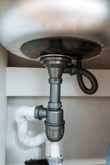 This elegantly designed sink features a stylishly hanging drain pipe from its underside, showcasing...