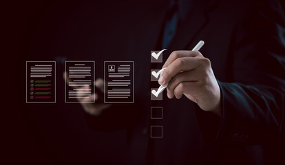 Businessman using stylus to complete digital checklist icons, symbolizing effective management,...