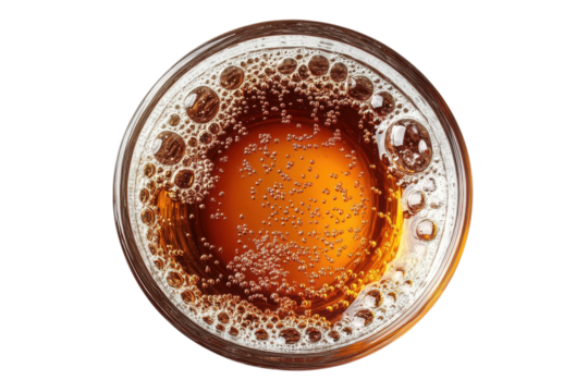 Amber beer effervescent bubbles in a glass top view close up dark background refreshing drink golden liquid carbonated