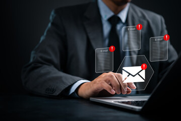 Email warning icons popping up on computer screen, representing inbox overload and phishing alert....