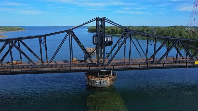 Little current swing bridge at sunny summer with blue sky. The bridge connects Manitoulin island and Goat island to the mainland and use for boats pass.