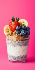 Fresh Chia Pudding with Fruit and Granola on Pink Background