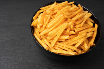 Fried chips sticks, finger potato chips, golden shoestring fries pile, French fries