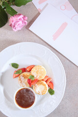 Cheesecakes with strawberries and jam. Healthy breakfast. The menu page. View from above.