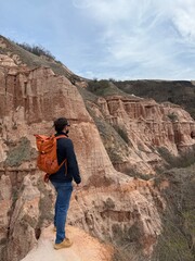 Hiker Overlooking the Red Ravines of Râpa Roșie, Romania