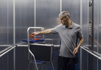 Elevator mechanic repairing the elevator © stokkete