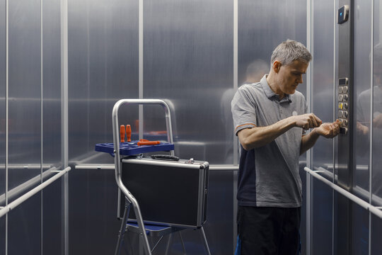 Elevator mechanic repairing the elevator