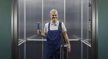 Portrait of a plumber standing in an elevator © stokkete