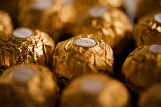 Moscow, Russia - April 11, 2025: background of Ferrero Rocher chocolates in golden foil close up.