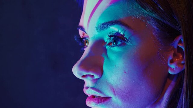 Woman illuminated by digital flickering lights, futuristic tech-inspired portrait