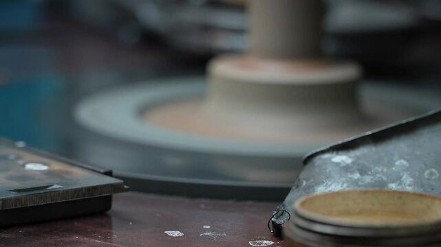 Diamond Polishers at Work at the Wheel in the Diamond Polishing Factory.The machine for diamond cutting. A polisher brillianteers the final facets of a gem attached to a drop on rotating cast iron lap