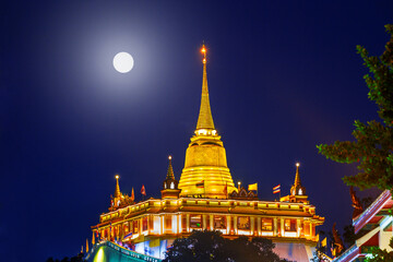 Golden Mountain or Wat Saket Ratcha Wora Maha Wihan at night on full moon day in  Bangkok one of the Landmarks of Thailand