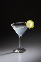 Fresh margarita cocktail with lemon, salt, on dark background, stock