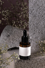 Amber Dropper Bottle on Stone Surface with Blank Label for Branding Mockup