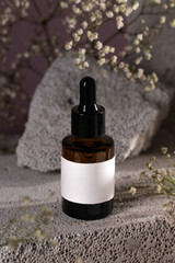 Amber Dropper Bottle on Stone Surface with Blank Label for Branding Mockup