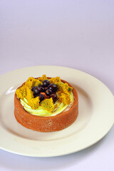 Bright fruit and berry cake with cream on shortcrust pastry