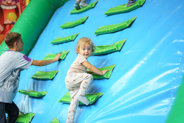 A little girl plays in a children's playground.