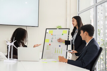 Strategy Presentation and Environmental Advocacy. A professional highlights ESG data insights in a team meeting.