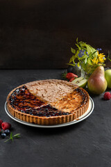 Berry round shortbread tart on dark grey background