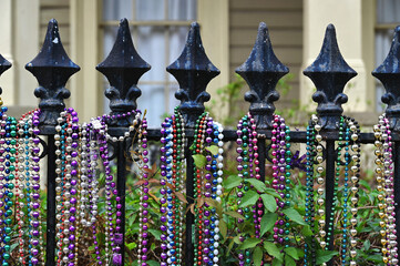 Mardi Gras beads hanging on a fence
