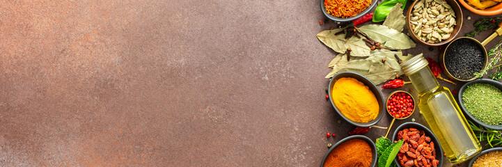 A visually striking arrangement of fresh spices and herbs on a brown surface, highlighting their...