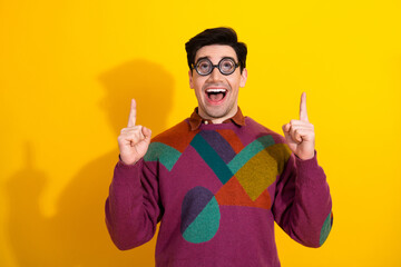Excited Young Man Wearing Colorful Sweater Showing Gesture on Yellow Background