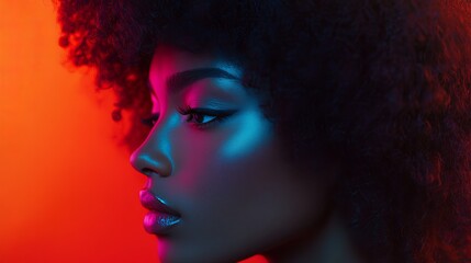 Fototapeta premium Profile of a woman with afro hair in neon lighting with red and blue color gradients and winged eyeliner