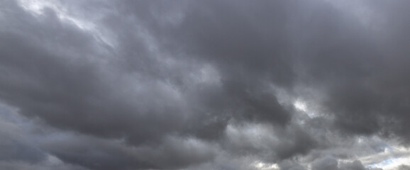 The sky is dark and cloudy, with a few raindrops falling