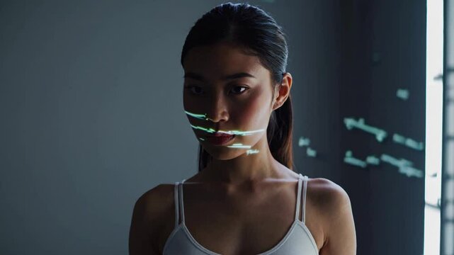 The integration of technology and human expertise in software development is presented by a young Asian woman programmer in front of an LCD screen with code projected
