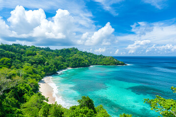 Fototapeta premium stunning coastal view featuring vibrant turquoise sea, lush green hills, and fluffy white clouds, evoking sense of tranquility
