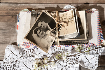 old family photographs, pictures from 1935 in sepia color on wooden table, home archive documents,...