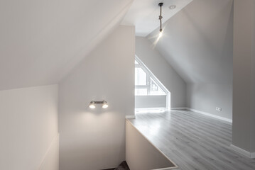 Modern Attic Space with Bright Minimalist Interior Design and Wooden Flooring