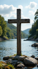 A weathered wooden cross set against a tranquil river backdrop with mountains in the distance under a clear sky.